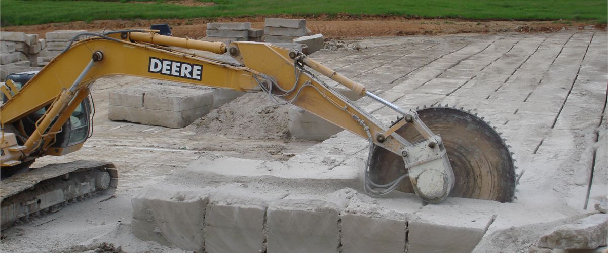 Excavator fitted with a Rock Tools Attachments tungsten rock saw cutting through stone